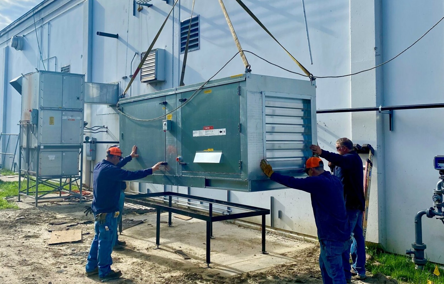 Installing a commercial air make-up unit on building rooftop by LG Mechanical