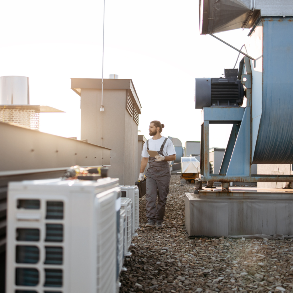 Technician inspecting furnace units for performance and maintenance