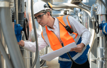 Technician maintaining commercial furnace unit for optimal system performance